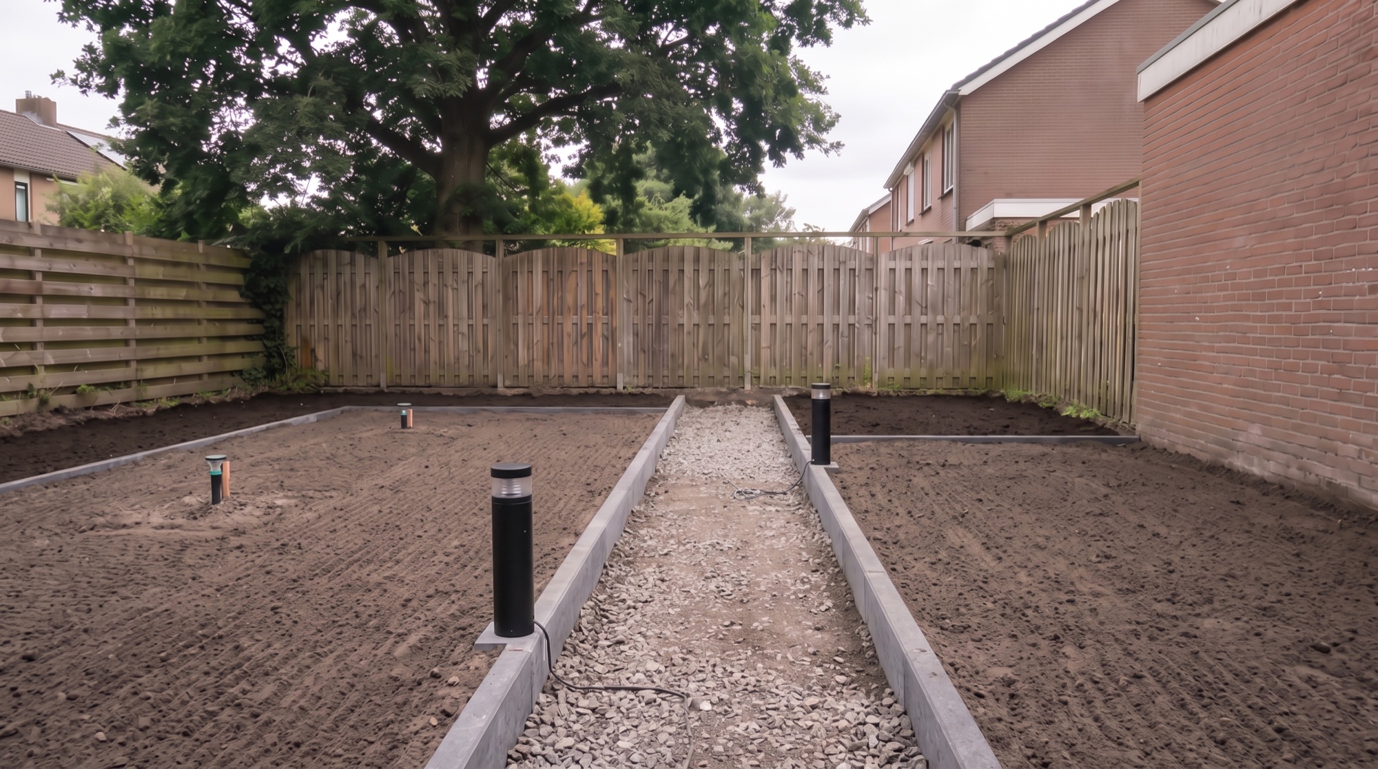 A compacted crushed-stone base in the path with bollard lights along the border
