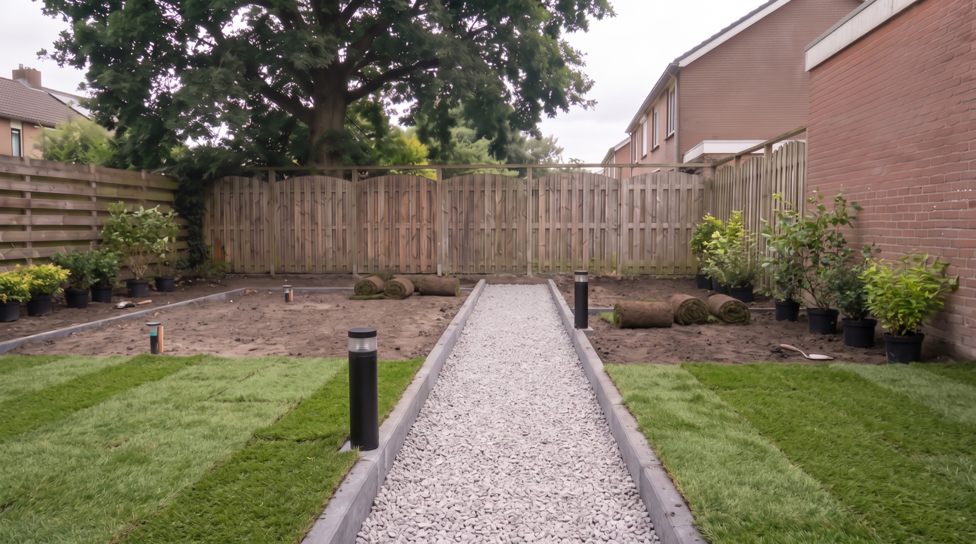 Fresh turf rolled out beside a raked gravel path